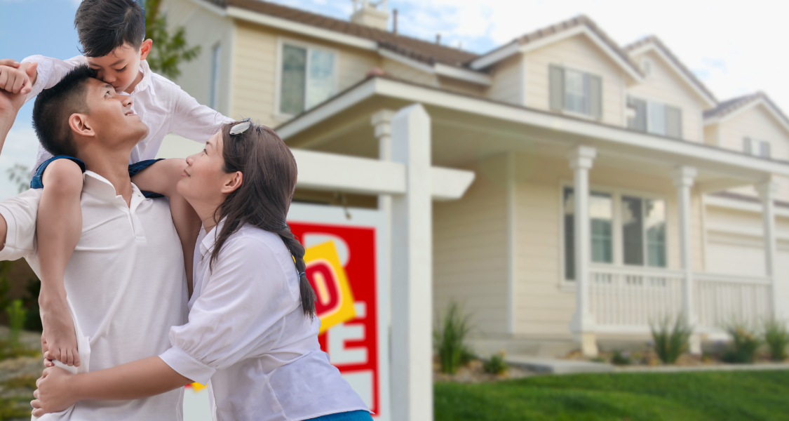 family in front of their sold home